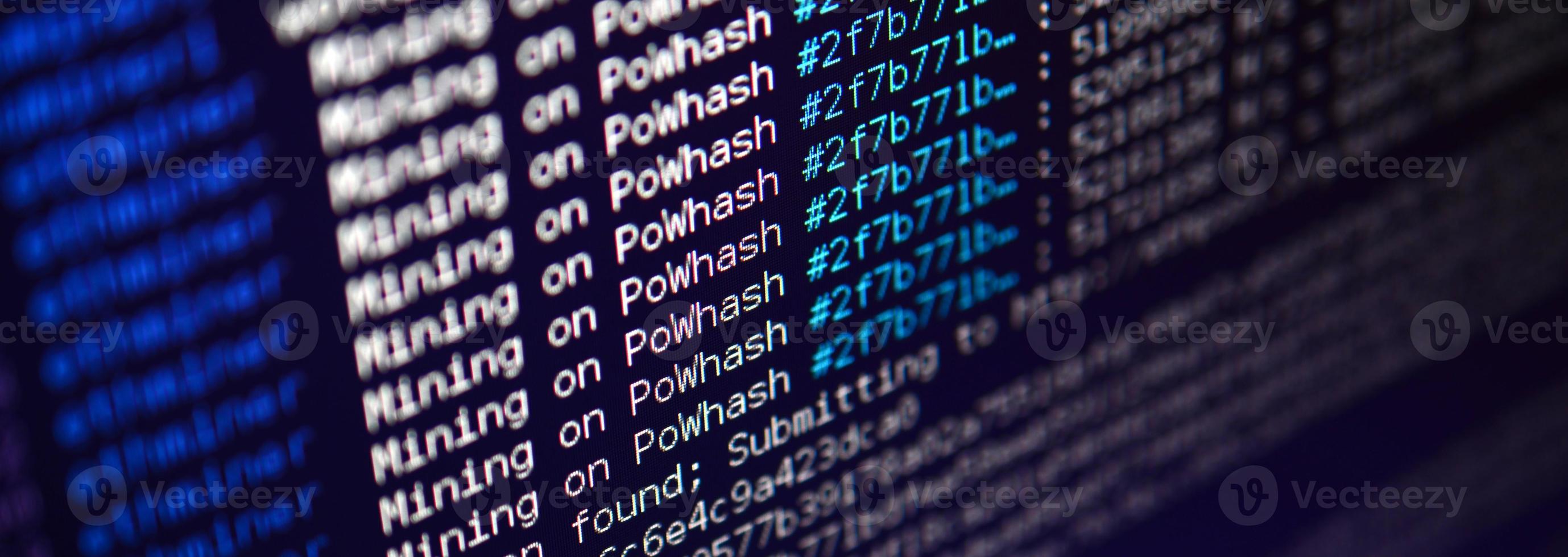 Macro snapshot of the program interface for crypto currency mining on the monitor of an office computer. The concept of mining bitcoins. The flow of information strings and data photo