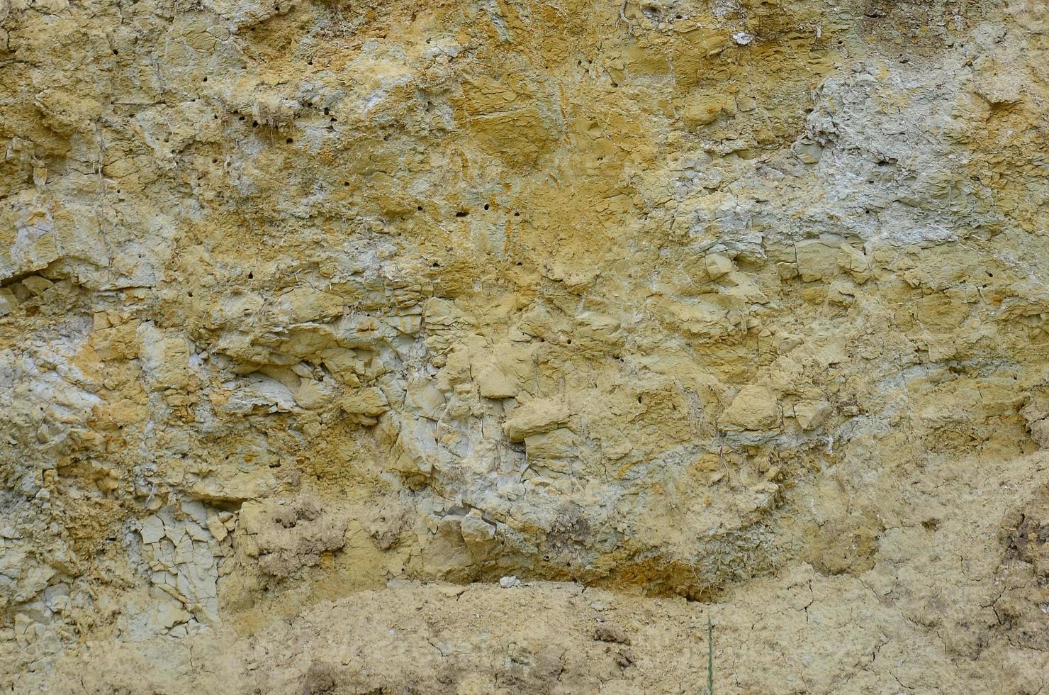 Texture of a wall of solid yellow and brown sand in a sandy quarry photo