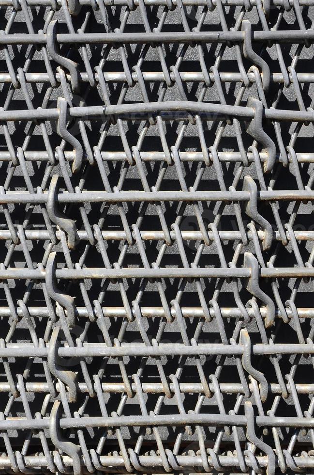 Metal multilayered thick grid of black color. Composite texture photo