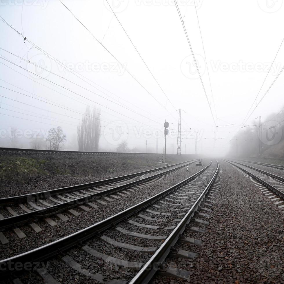 The railway track in a misty morning. A lot of rails and sleepers go into the misty horizon. Fisheye photo with increased distortion