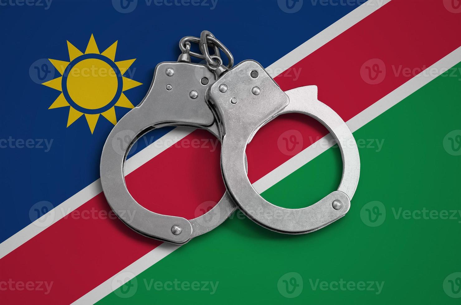 Namibia flag  and police handcuffs. The concept of observance of the law in the country and protection from crime photo