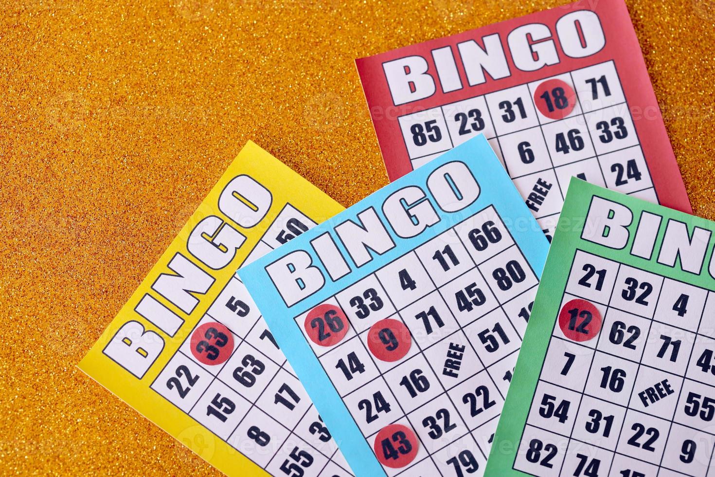 Many colorful bingo boards or playing cards for winning chips. Classic US or canadian five to five bingo cards on bright background photo