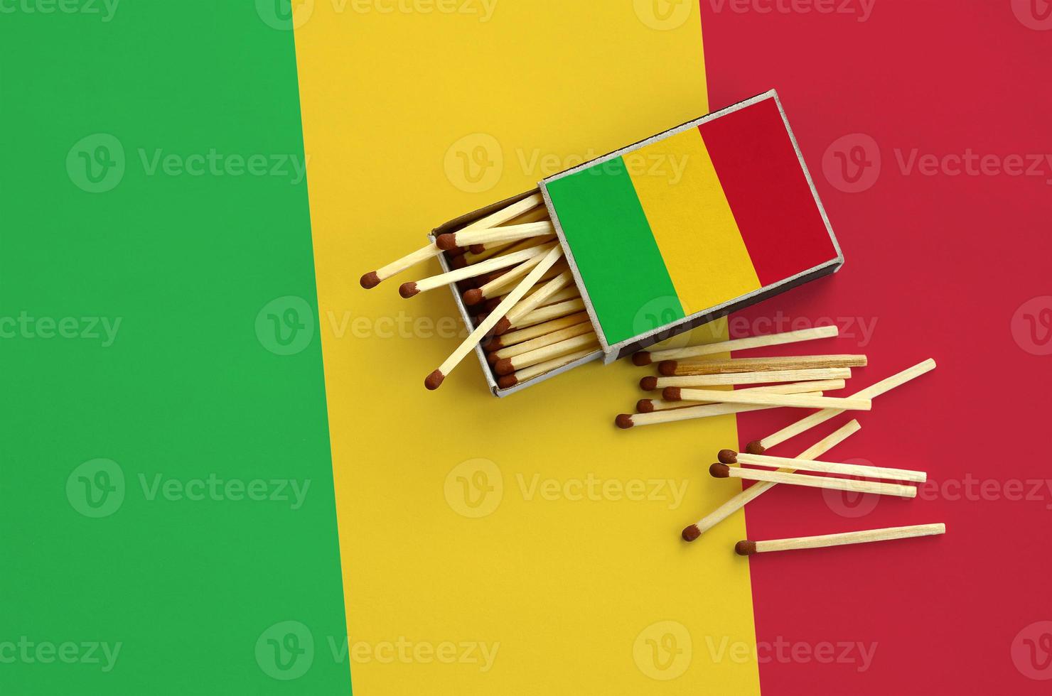 Mali flag  is shown on an open matchbox, from which several matches fall and lies on a large flag photo