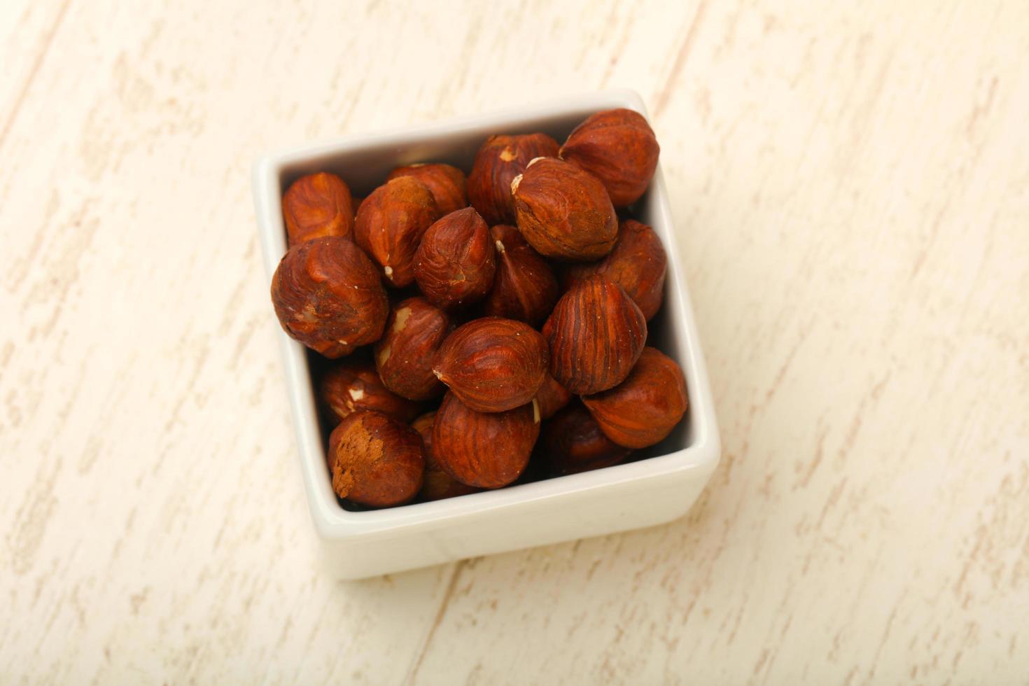 Hazelnut heap on wood photo