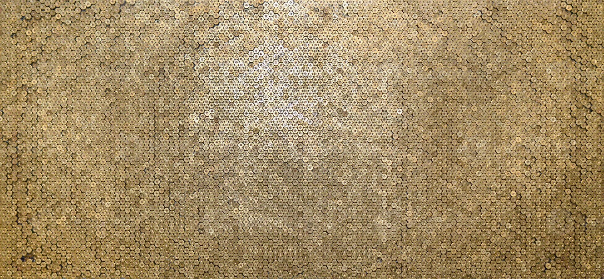 Pattern of 12 gauge cartridges for shotgun bullets. Shells for hunting rifle close up. Backdrop for shooting range or ammunition trade concepts photo