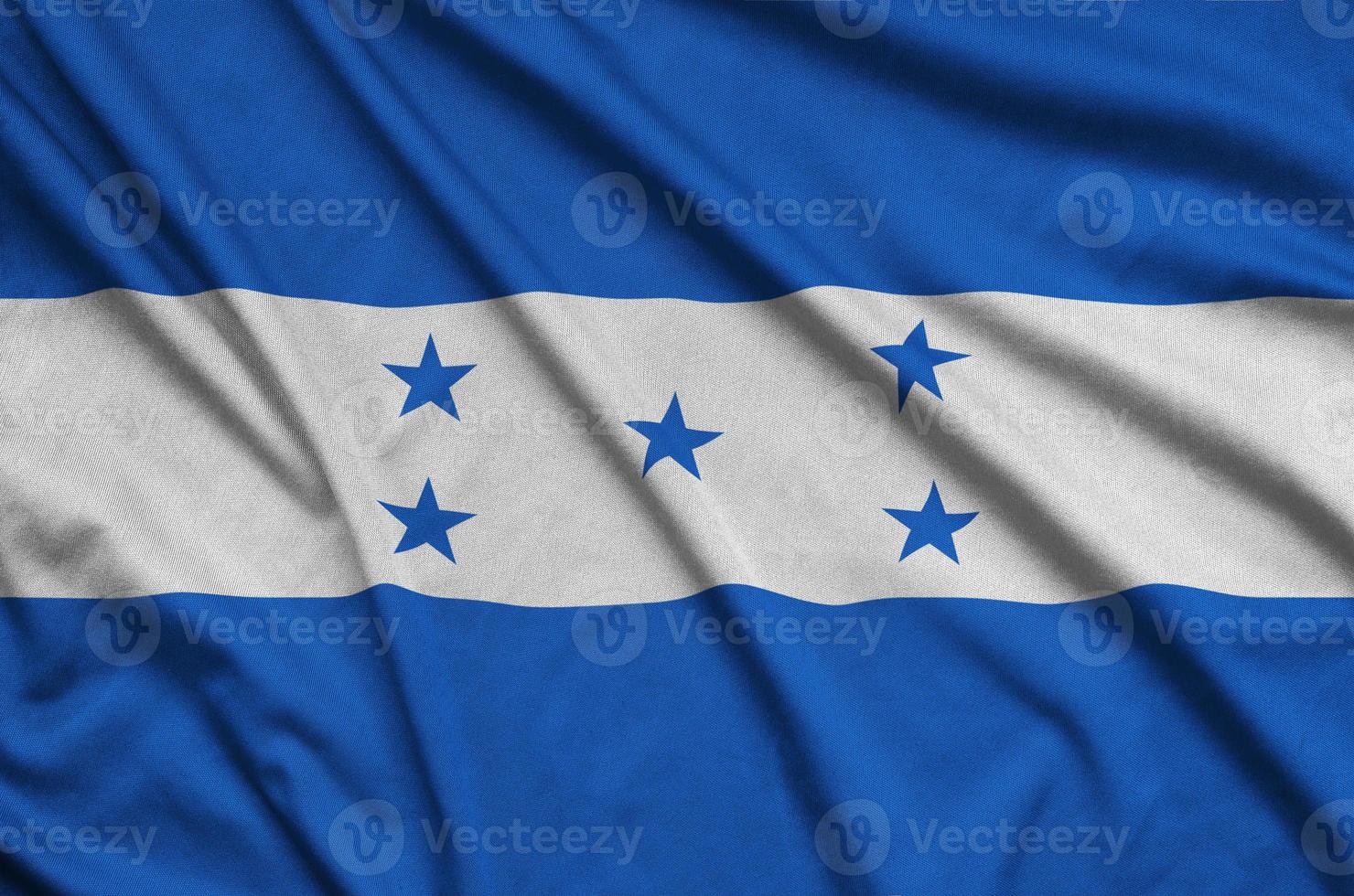 Honduras flag  is depicted on a sports cloth fabric with many folds. Sport team banner photo