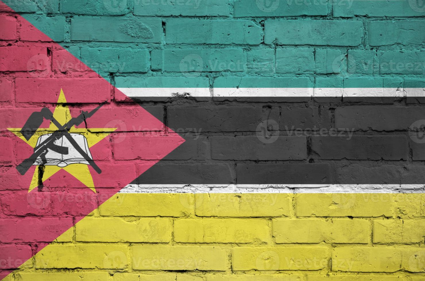 Mozambique flag is painted onto an old brick wall photo