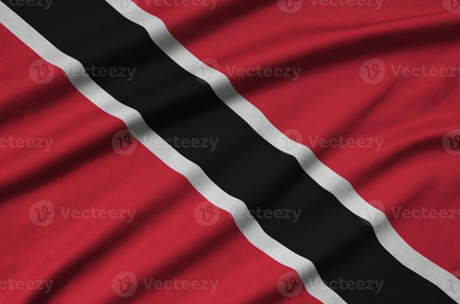 Trinidad and Tobago flag  is depicted on a sports cloth fabric with many folds. Sport team banner photo