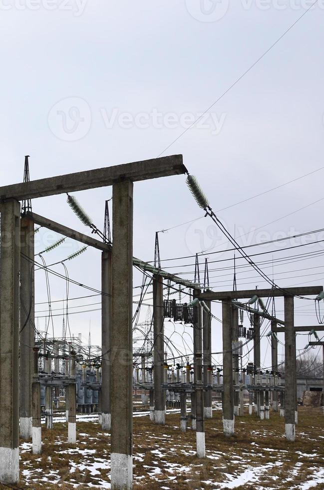 Power plant is a station of transformation. A lot of cables, poles and wires, transformers. Electro-energy. photo