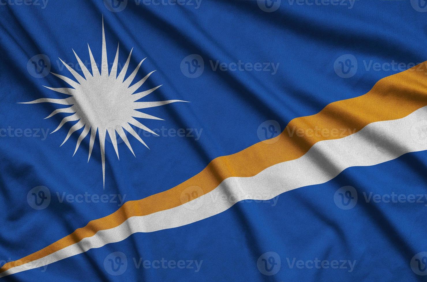 Marshall Islands flag  is depicted on a sports cloth fabric with many folds. Sport team banner photo