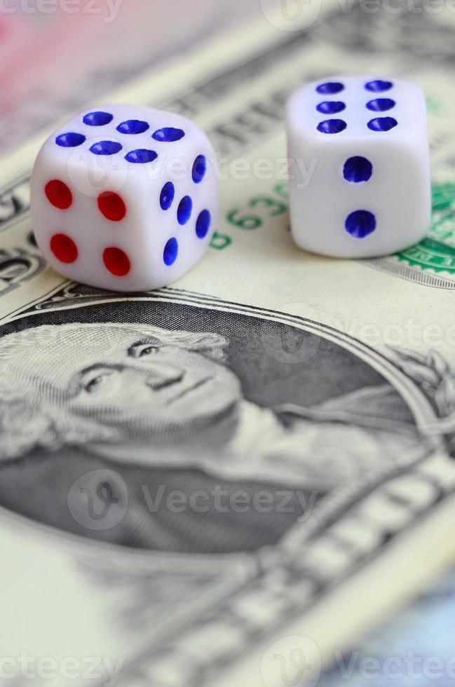 White dice are on a dollar bill of US dollars. The concept of gambling with rates in monetary units photo