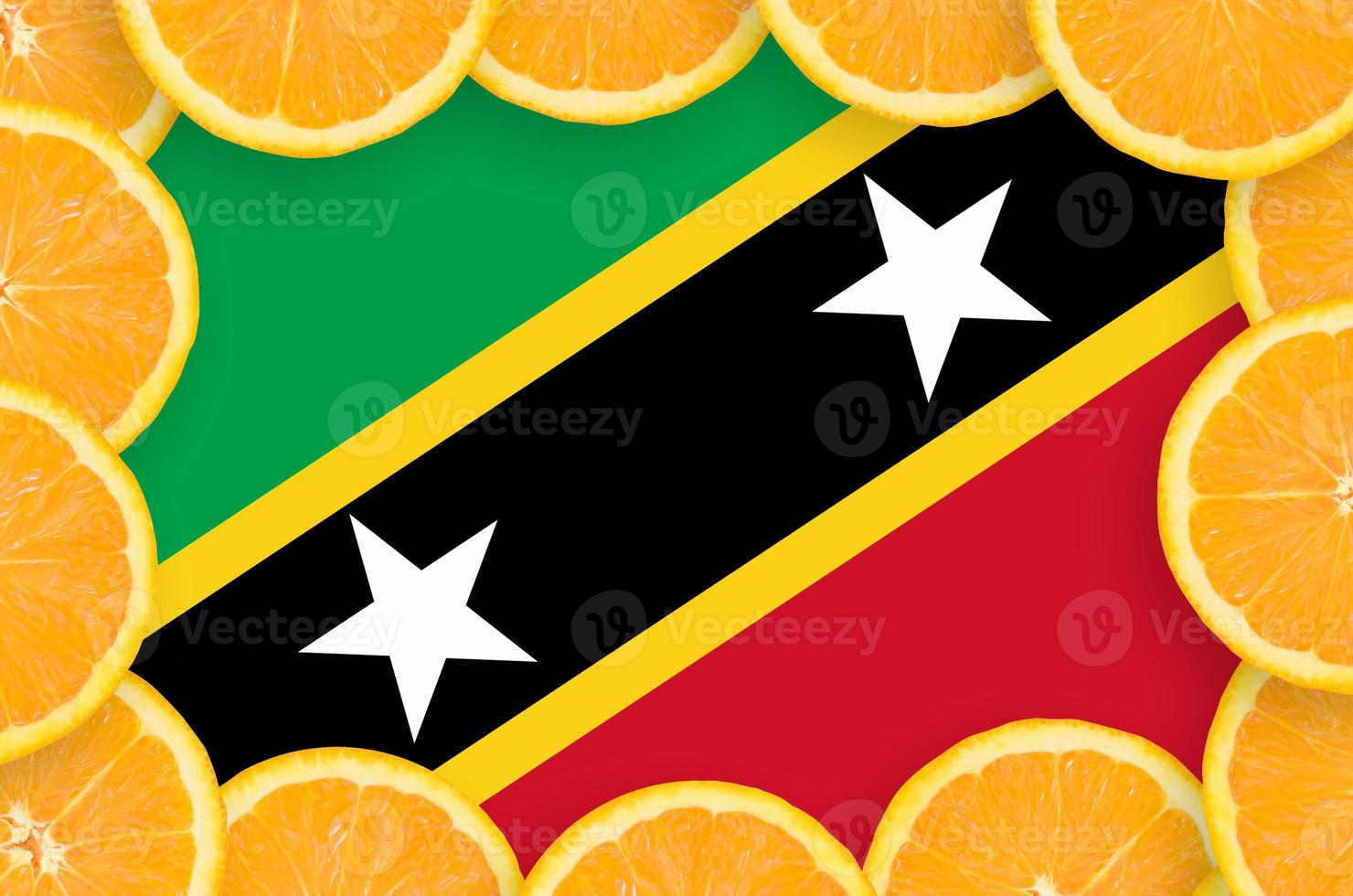 Saint Kitts and Nevis flag  in fresh citrus fruit slices frame photo