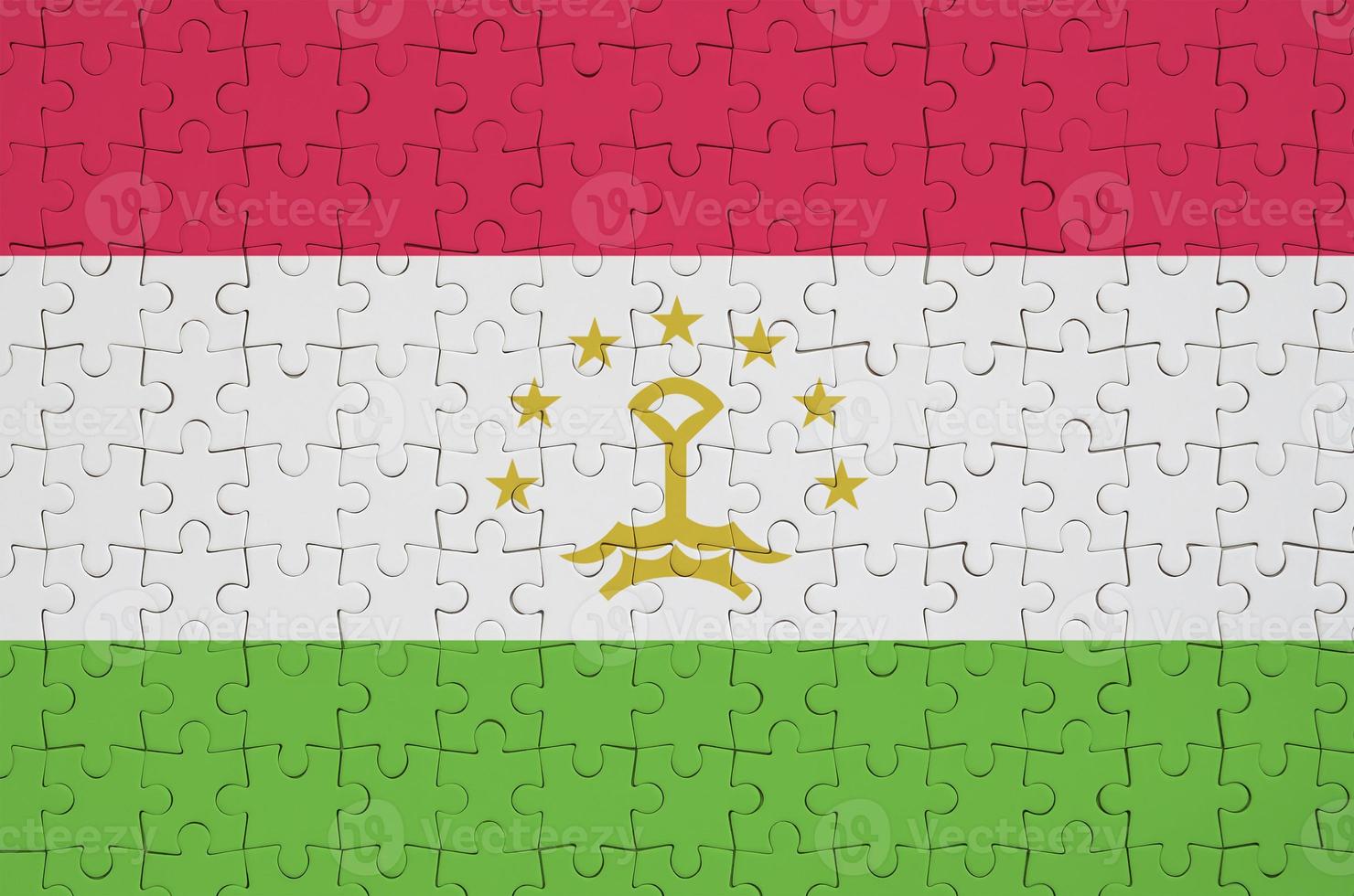 Tajikistan flag  is depicted on a folded puzzle photo