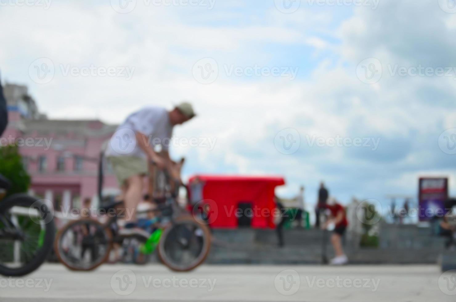 Defocused image of a lot of people with bmx bikes. Meeting of fans of extreme sports photo