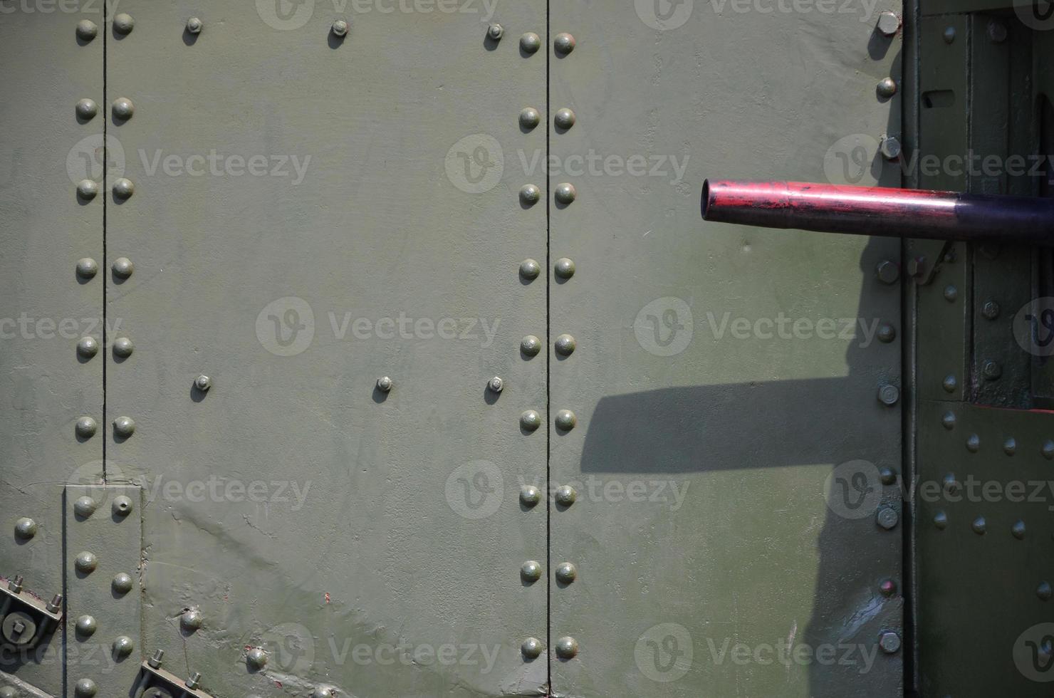 The texture of the wall of the tank, made of metal and reinforced with a multitude of bolts and rivets. Images of the covering of a combat vehicle from the Second World War with a guided machine gun photo