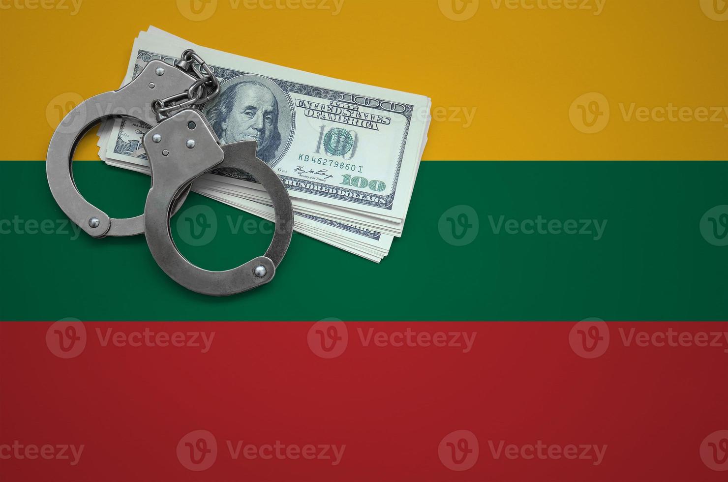 Lithuania flag  with handcuffs and a bundle of dollars. The concept of breaking the law and thieves crimes photo