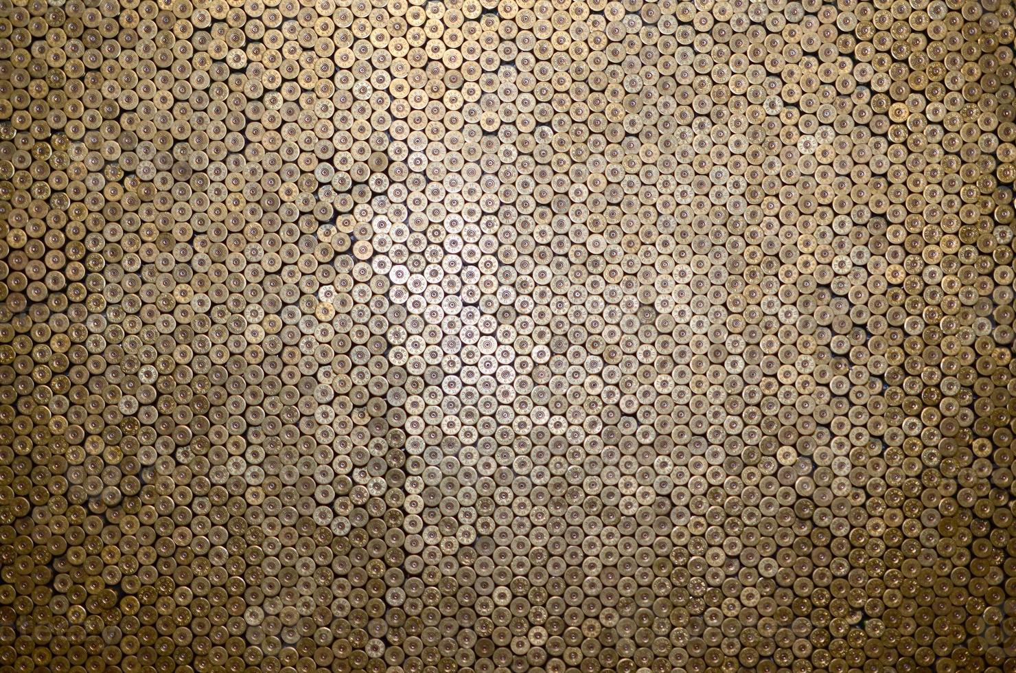 Pattern of 12 gauge cartridges for shotgun bullets. Shells for hunting rifle close up. Backdrop for shooting range or ammunition trade concepts photo