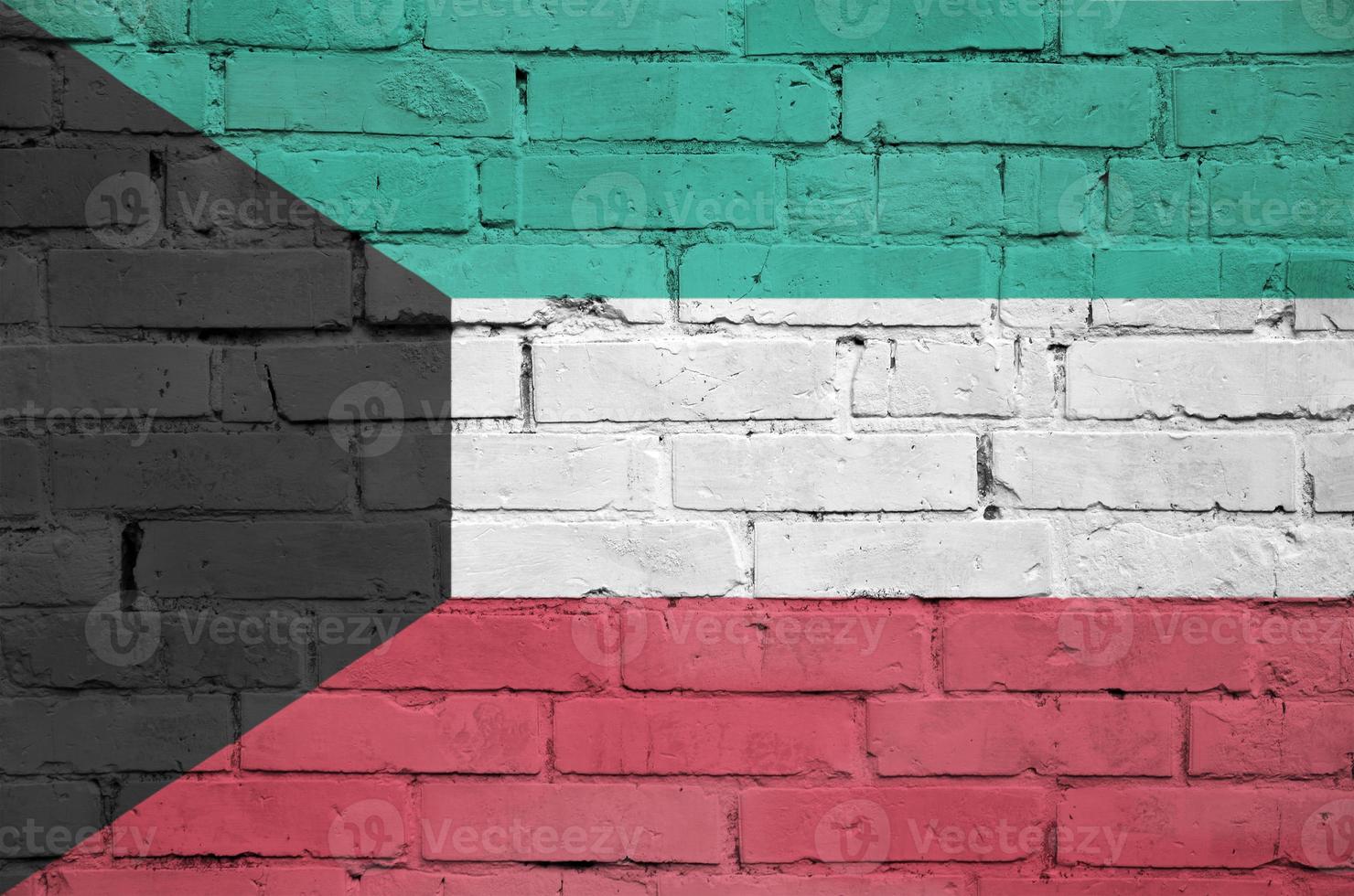 Kuwait flag is painted onto an old brick wall photo