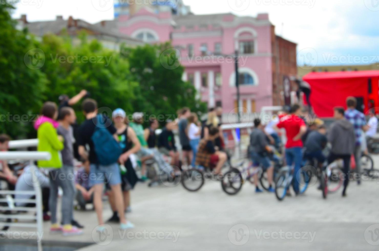 Defocused image of a lot of people with bmx bikes. Meeting of fans of extreme sports photo