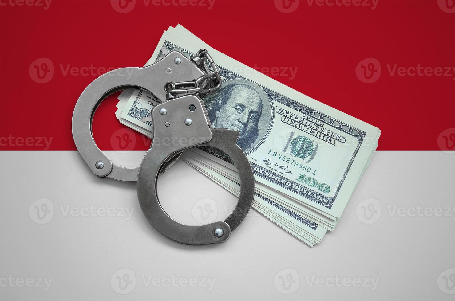 Indonesia flag  with handcuffs and a bundle of dollars. Currency corruption in the country. Financial crimes photo