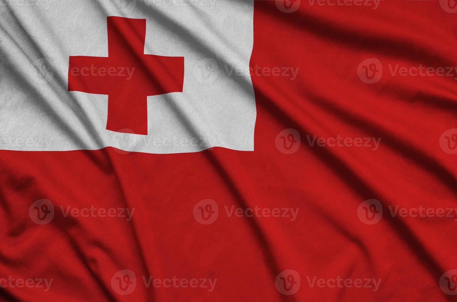 Tonga flag  is depicted on a sports cloth fabric with many folds. Sport team banner photo