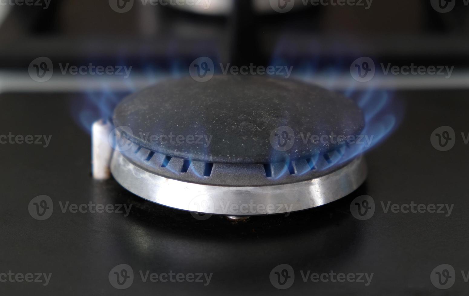 Close-up blue flames of fire on a gas burner in the kitchen for cooking. Gas flame in a gas boiler photo