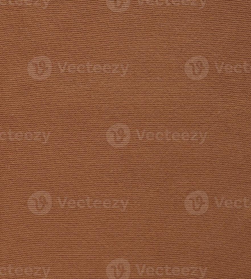 Banner with texture of smooth knitted red brown sweater with pattern. Top view, close-up. Handmade knitting wool or cotton fabric texture. Background of knitting patterns. photo