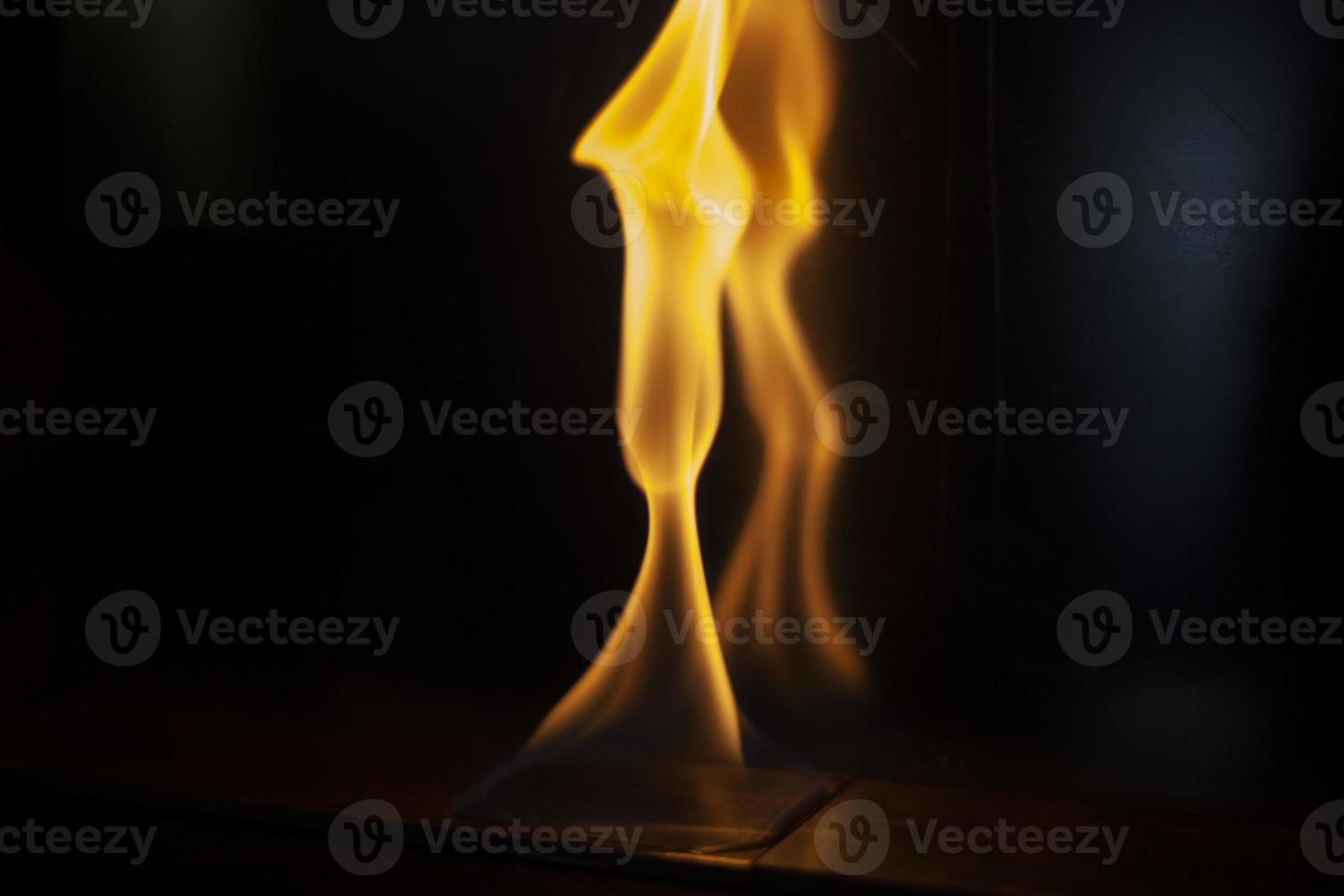 Fire in dark. Flame on black background. Alcohol burning. photo