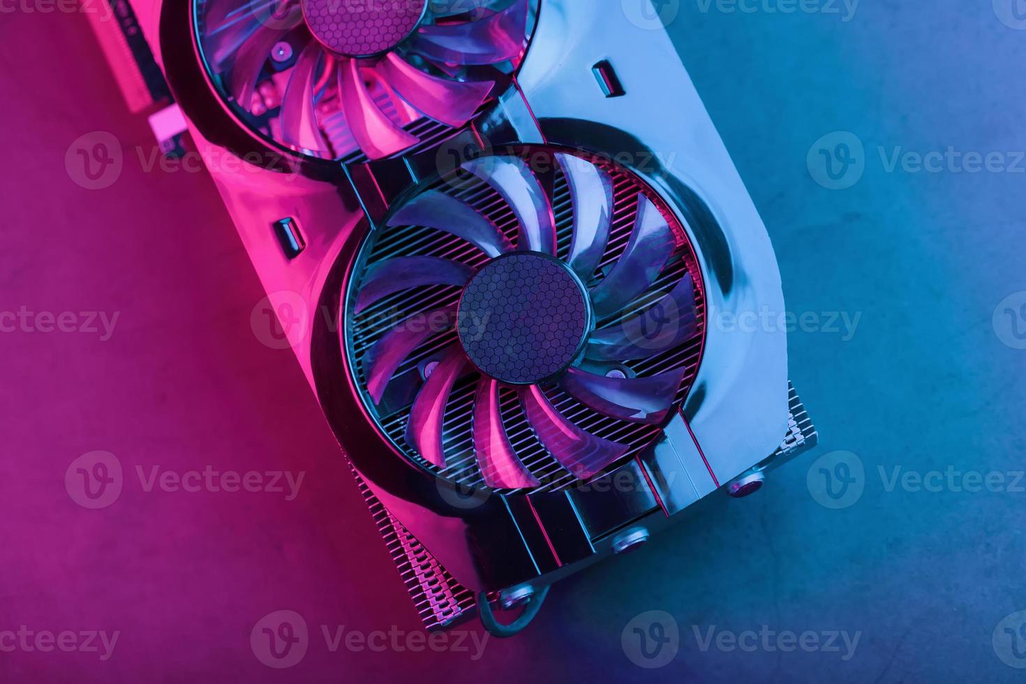 A graphics card with a row of fans with a cyanotic purple backlight in a futuristic design. photo