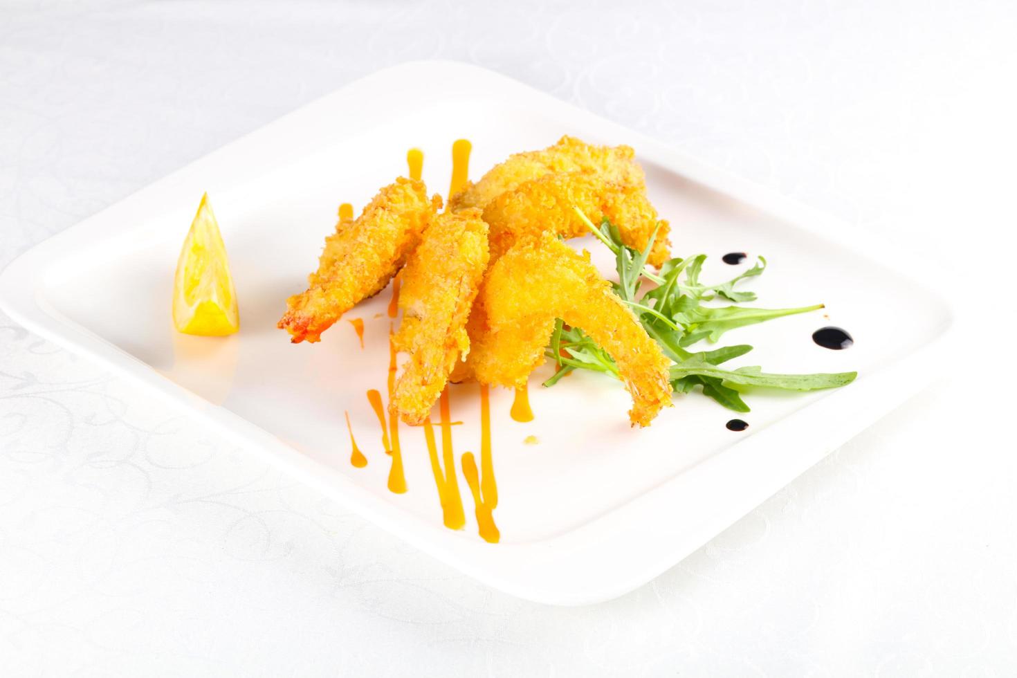 Crispy prawns on the plate and white background photo