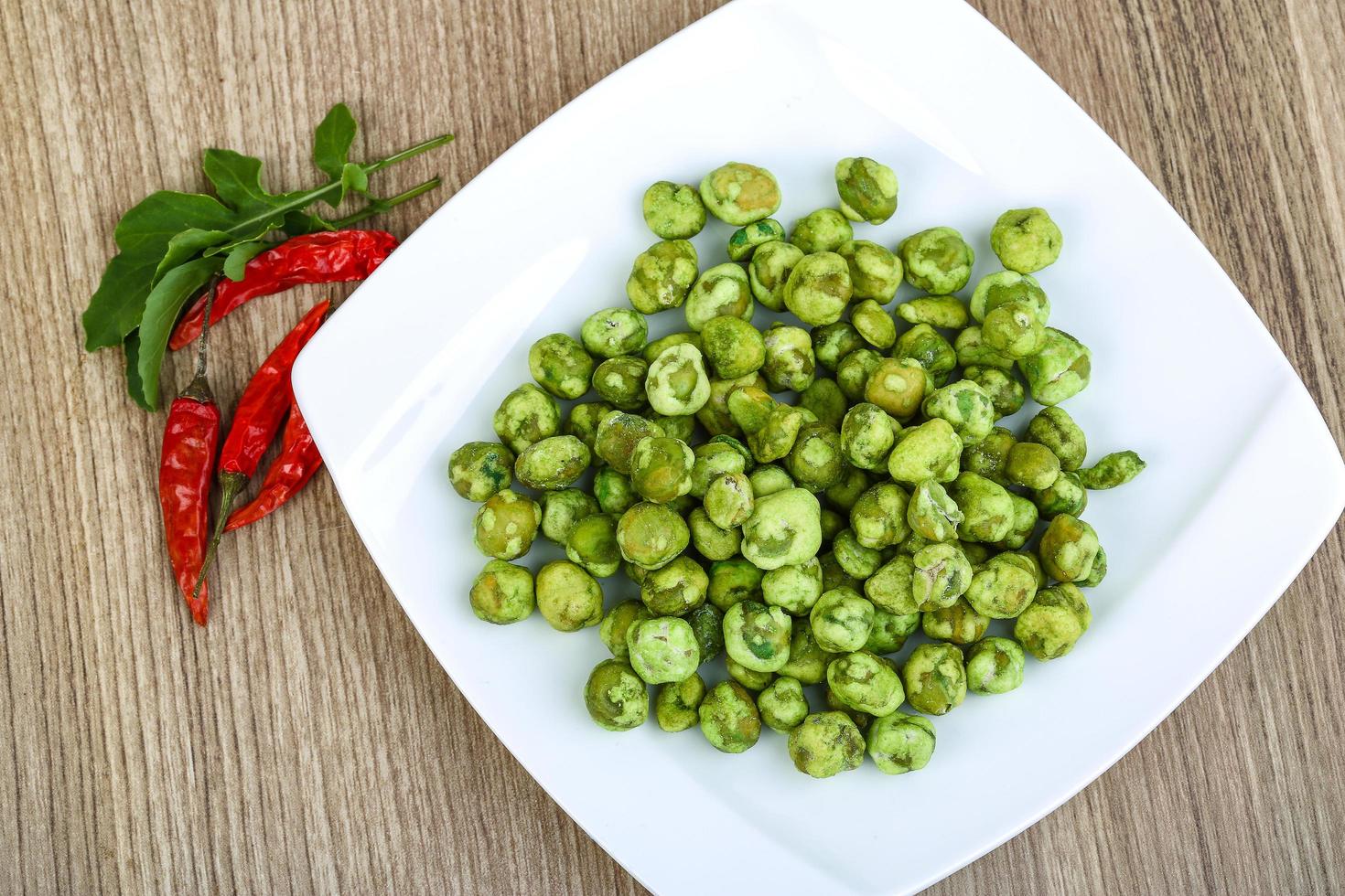Wasabi peas on wood photo