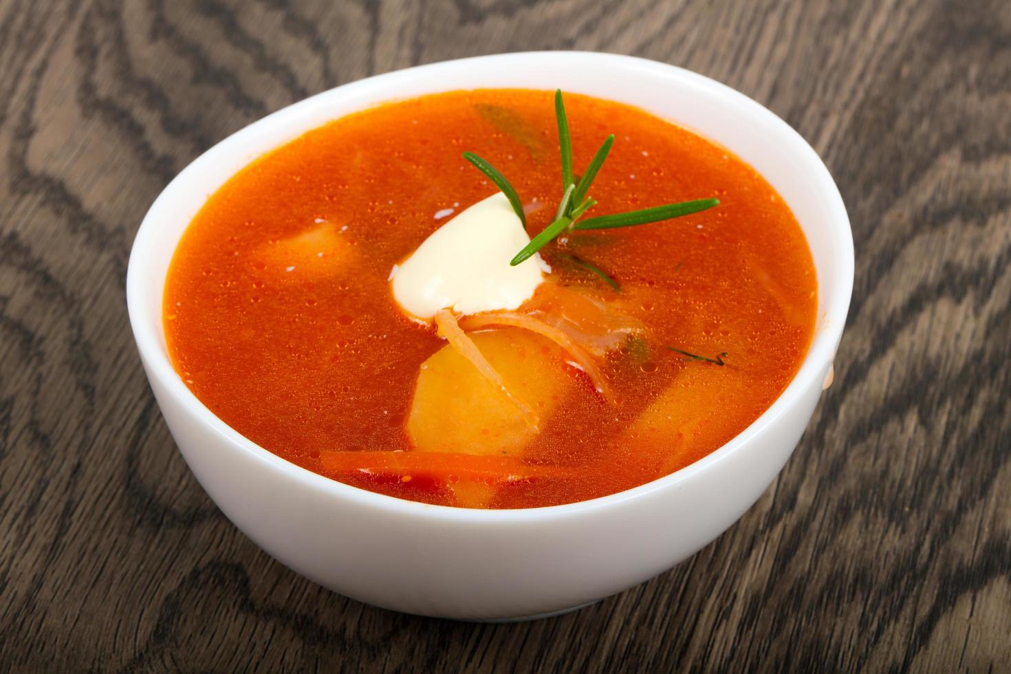 Russian Borcsh in a bowl on wooden background photo