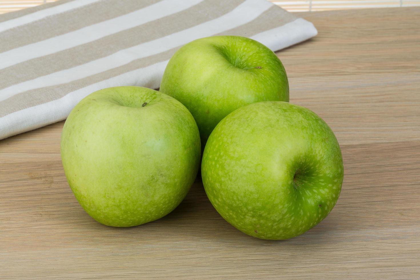 Green apple on wood photo