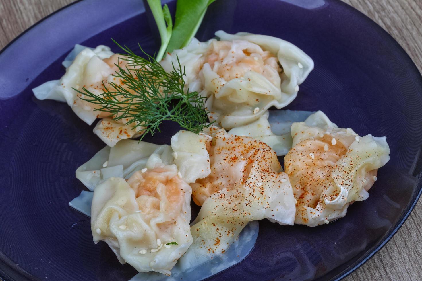 Shrimp wanton on the plate and wooden background photo