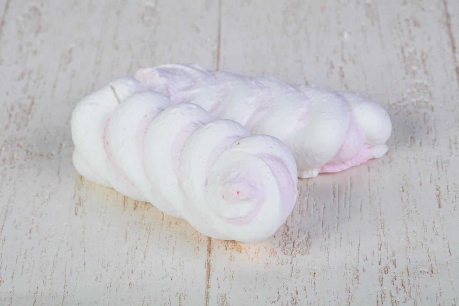 Delicious meringues on wooden background photo