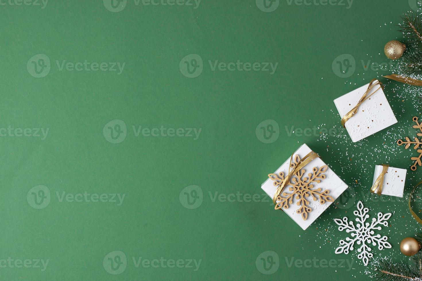 Christmas decorations with packaging gifts on green background. Flat lay, copy space photo