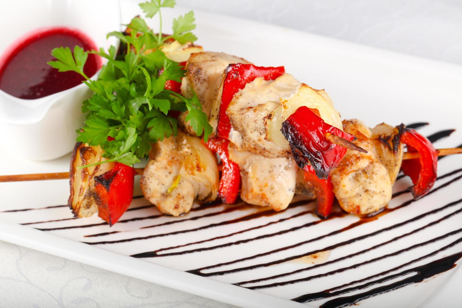 Chicken skewer on the plate and white background photo