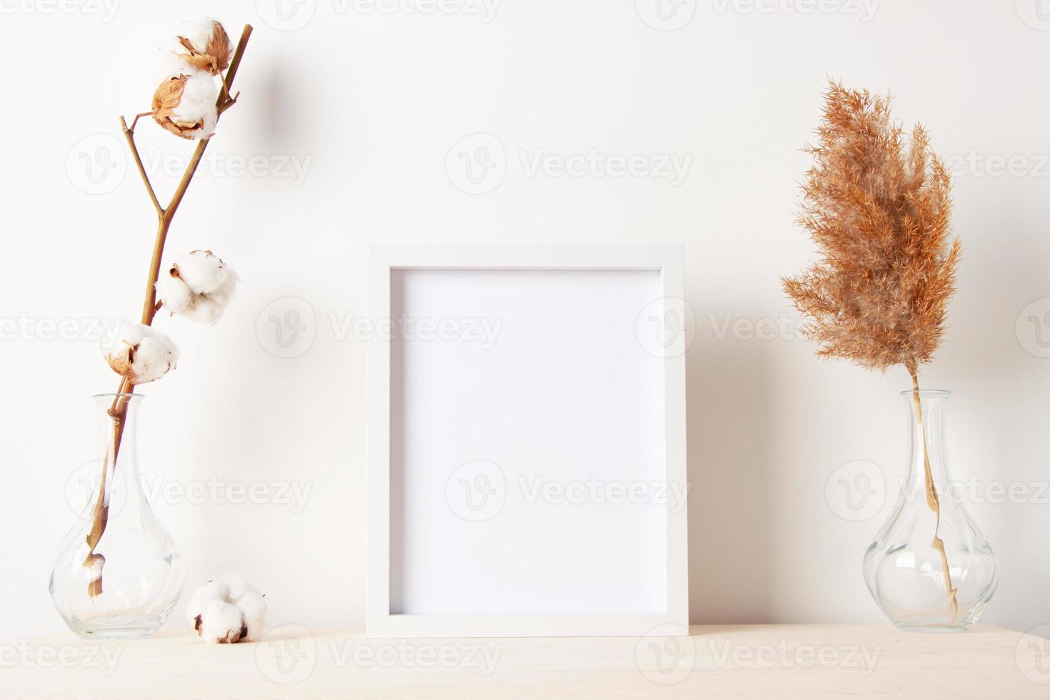 Home decoration with white mock up frame on table. Artwork showcase. Scandinavian style, copy space photo