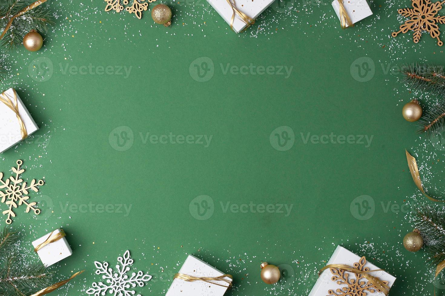 Christmas decorations with packaging gifts on green background. Flat lay, copy space photo