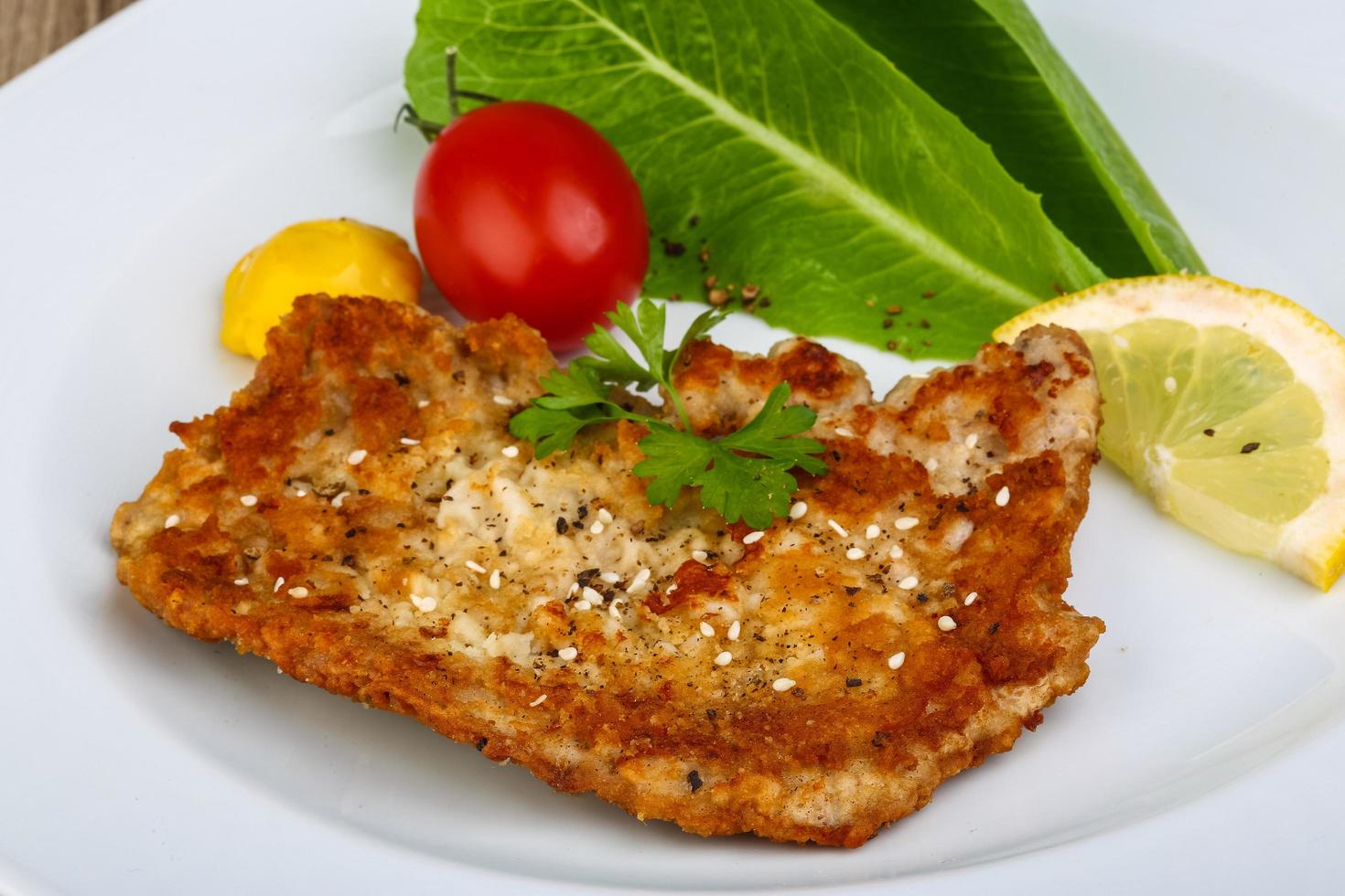 Pork schnitzel on the plate close up view photo