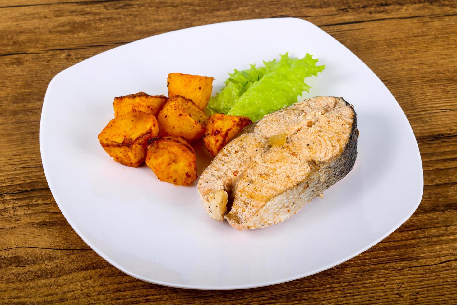 Steamed salmon on the plate and wooden background photo