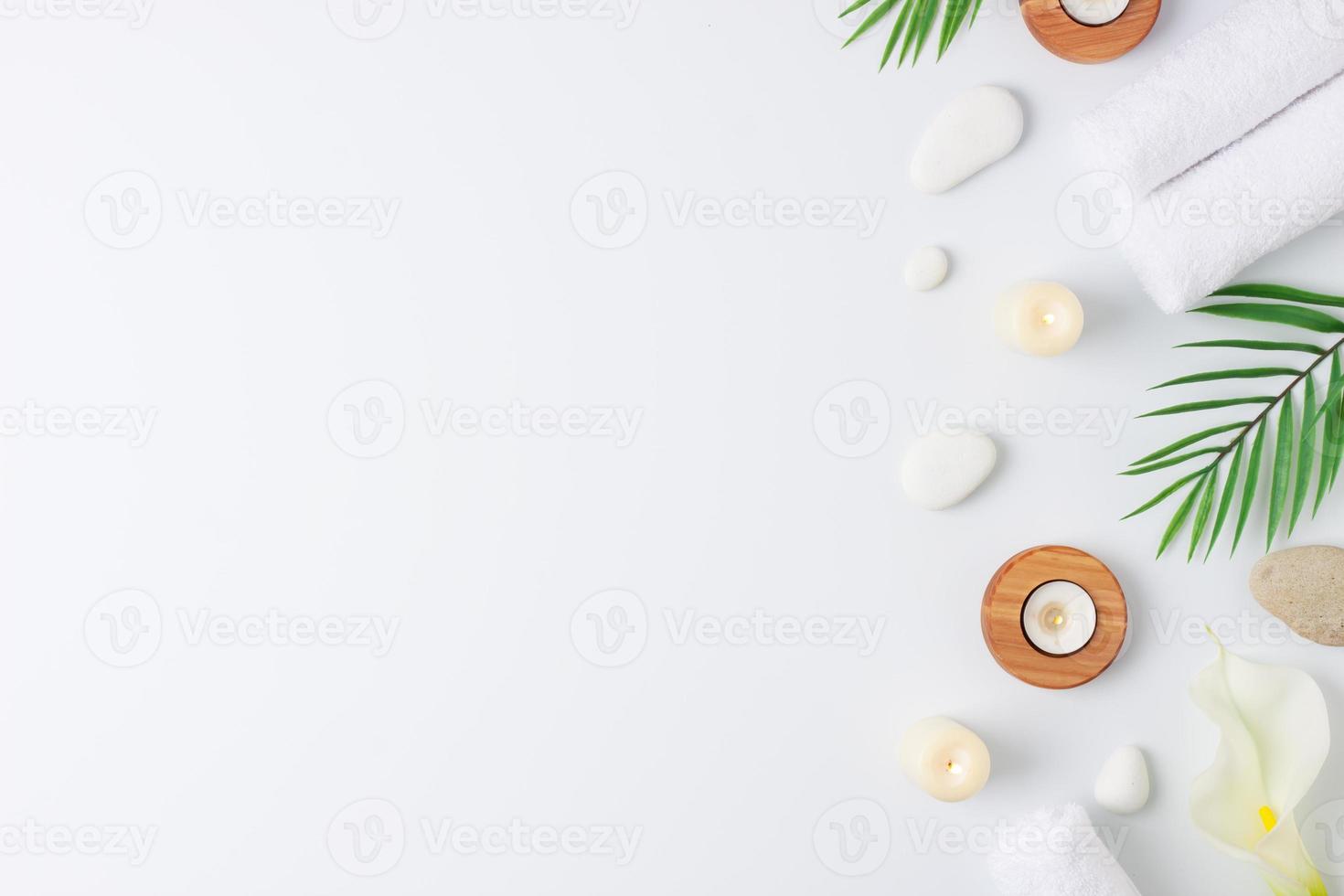 Spa treatment with towel, candles and palm on white background. Flat lay, copy space photo