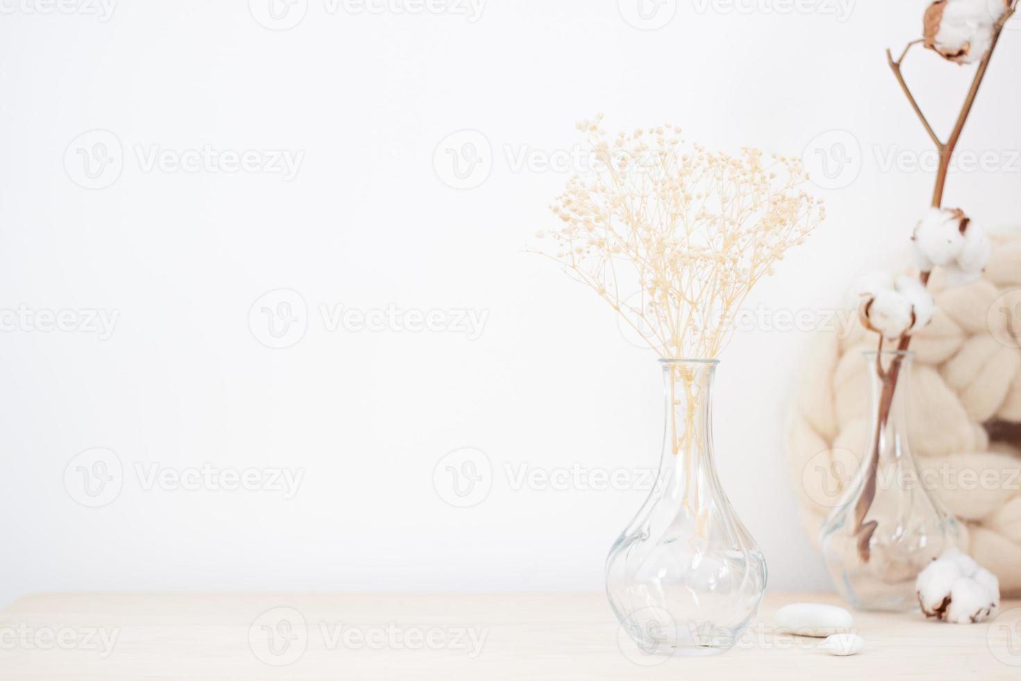 Home decoration with vase and flowers over white wall. Interior design concept. Close up, copy space photo