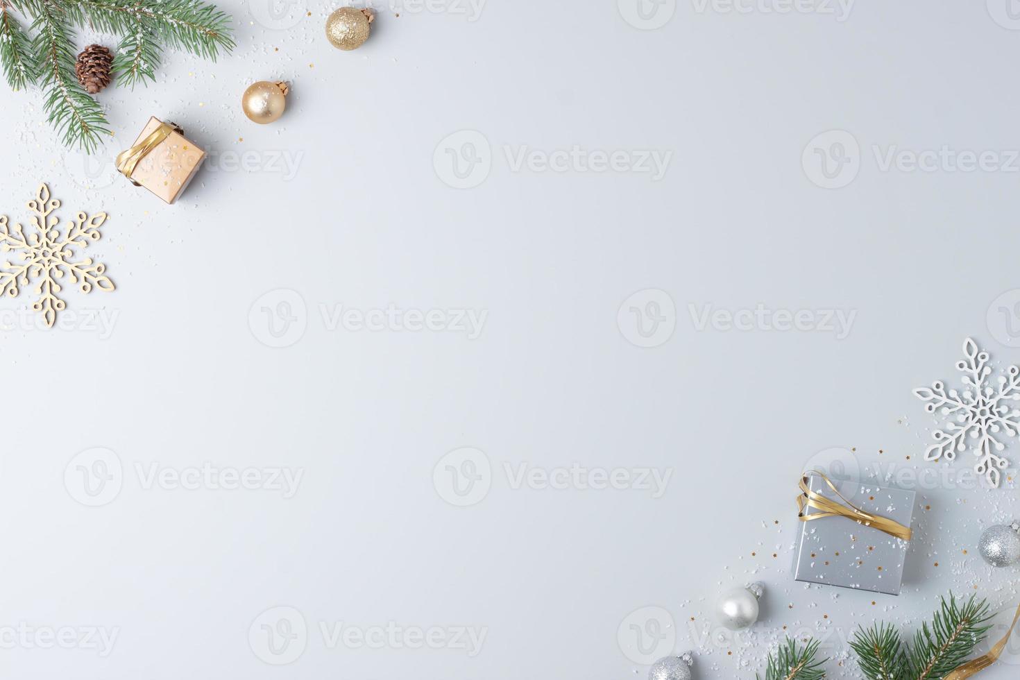 Christmas decorations with packaging gifts and Christmas tree on grey background. Flat lay, copy space photo
