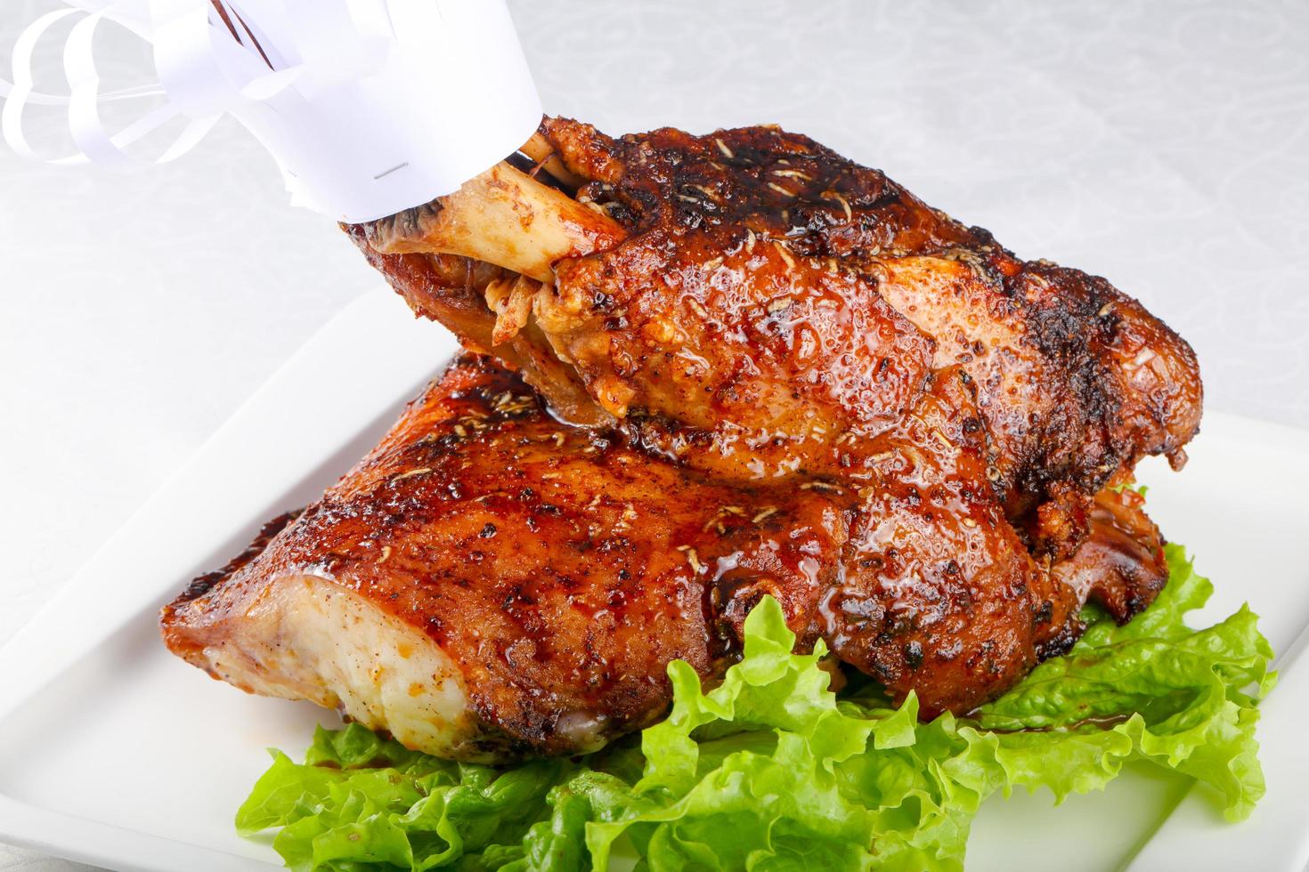 Pork leg on the plate and white background photo