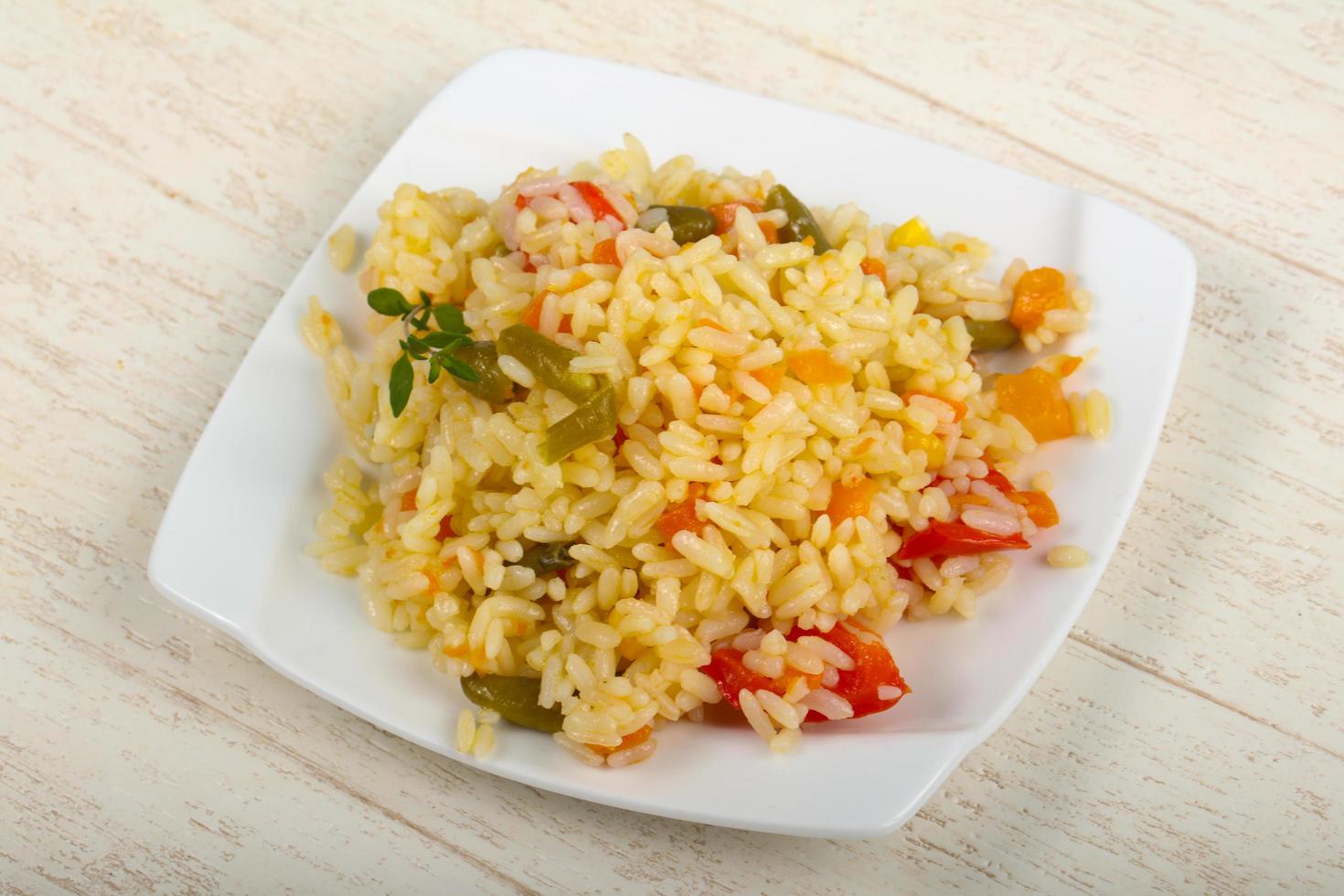 Mexican rice on the plate and wooden background photo