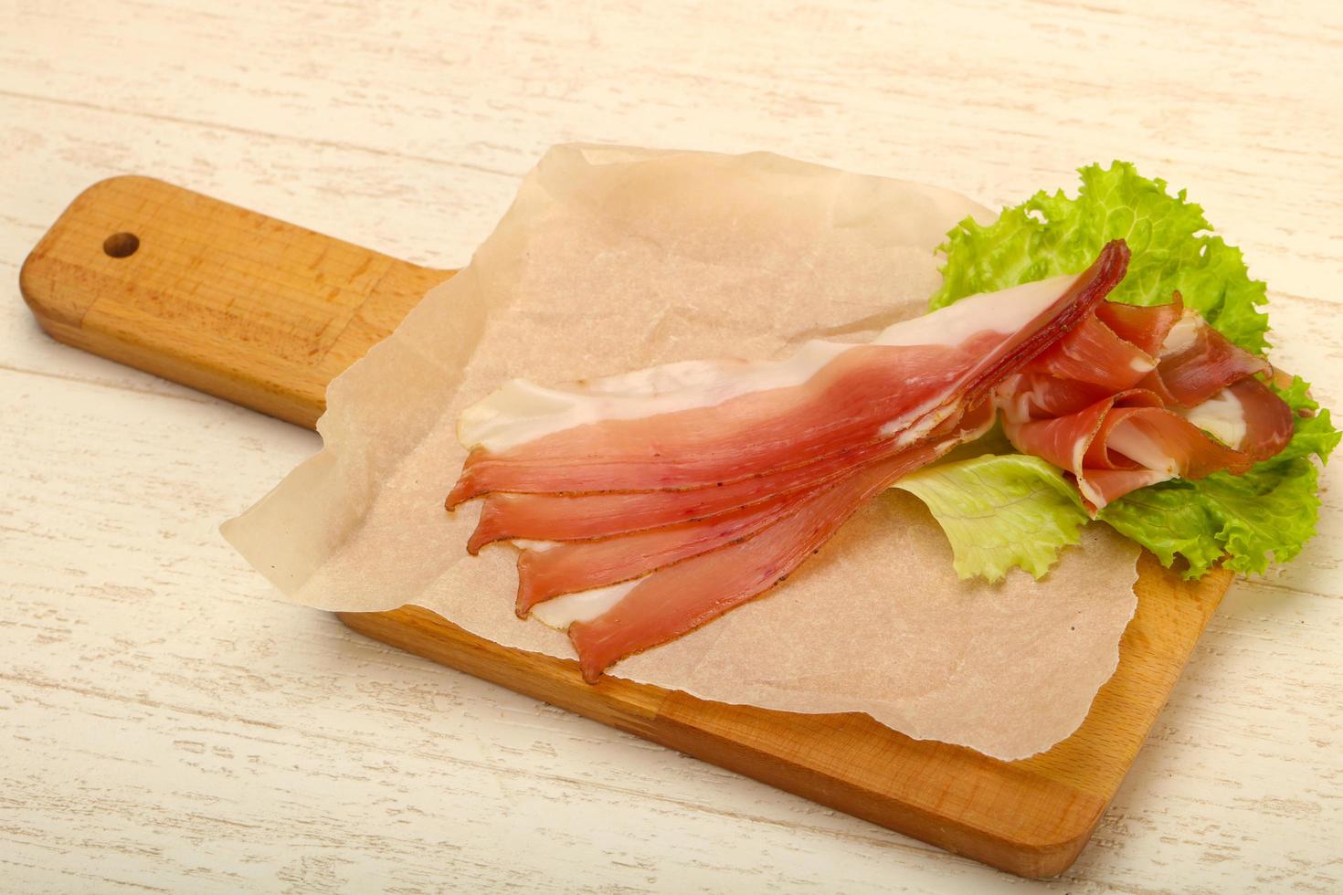 Hamon on wooden board and wooden background photo