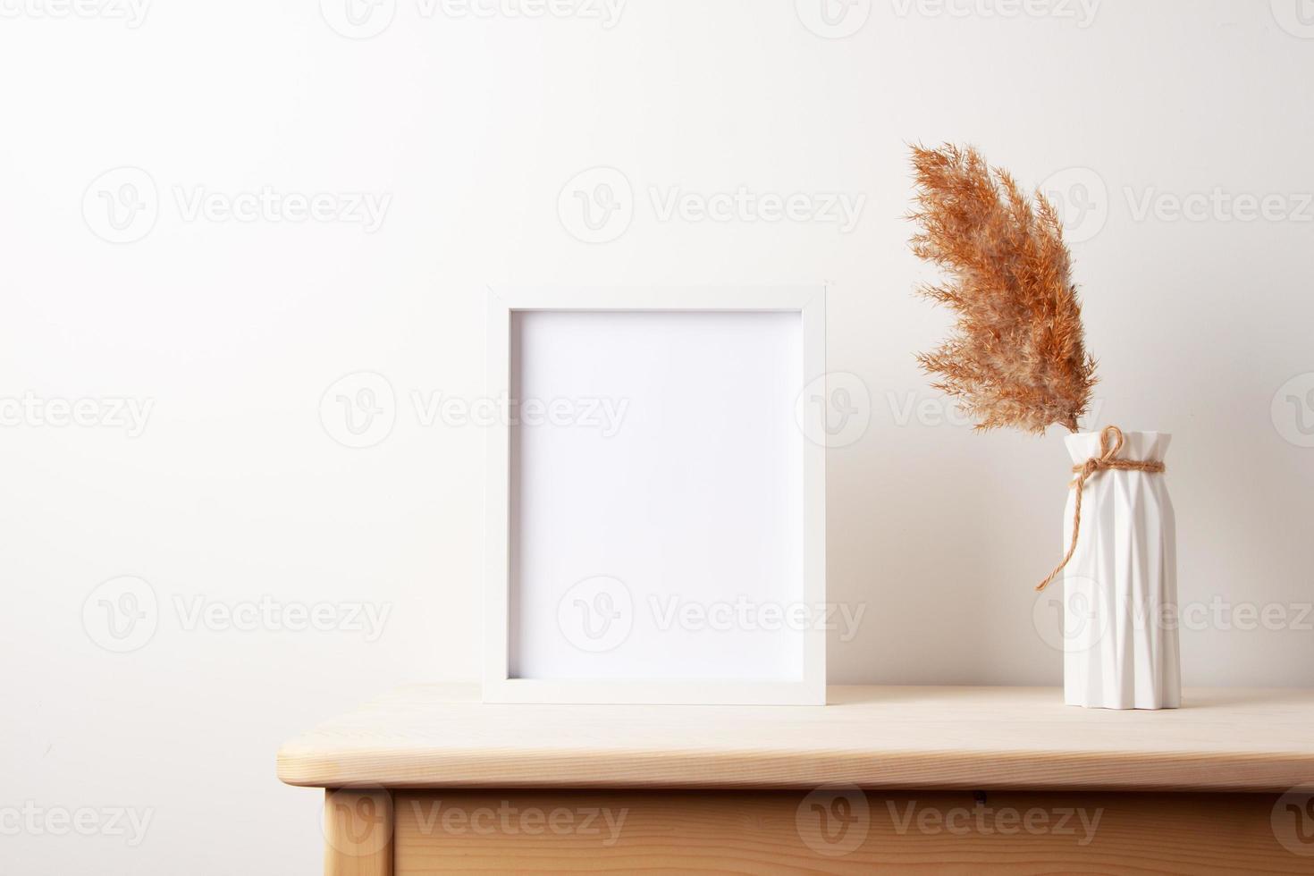 Home decoration with white mock up frame on table. Artwork showcase. Scandinavian style, copy space photo