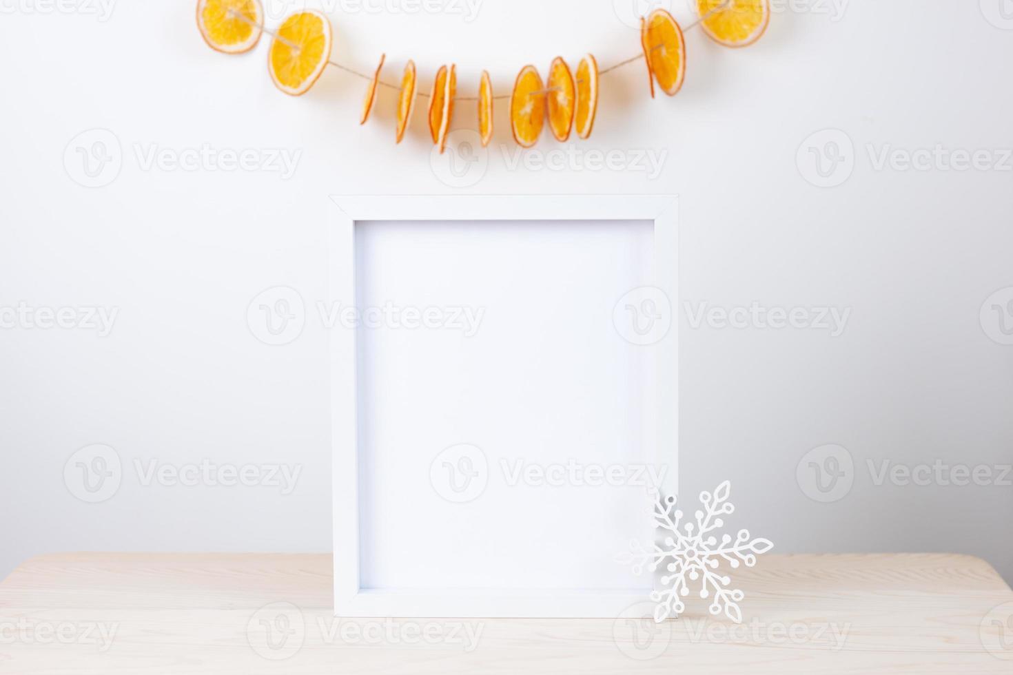 Zero waste Christmas natural decoration with white mock up frame on table. Close up, copy space photo
