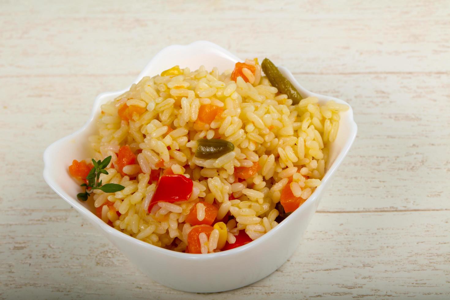 Mexican rice in a bowl on wooden background photo